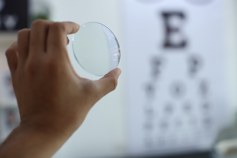 person holding up lens